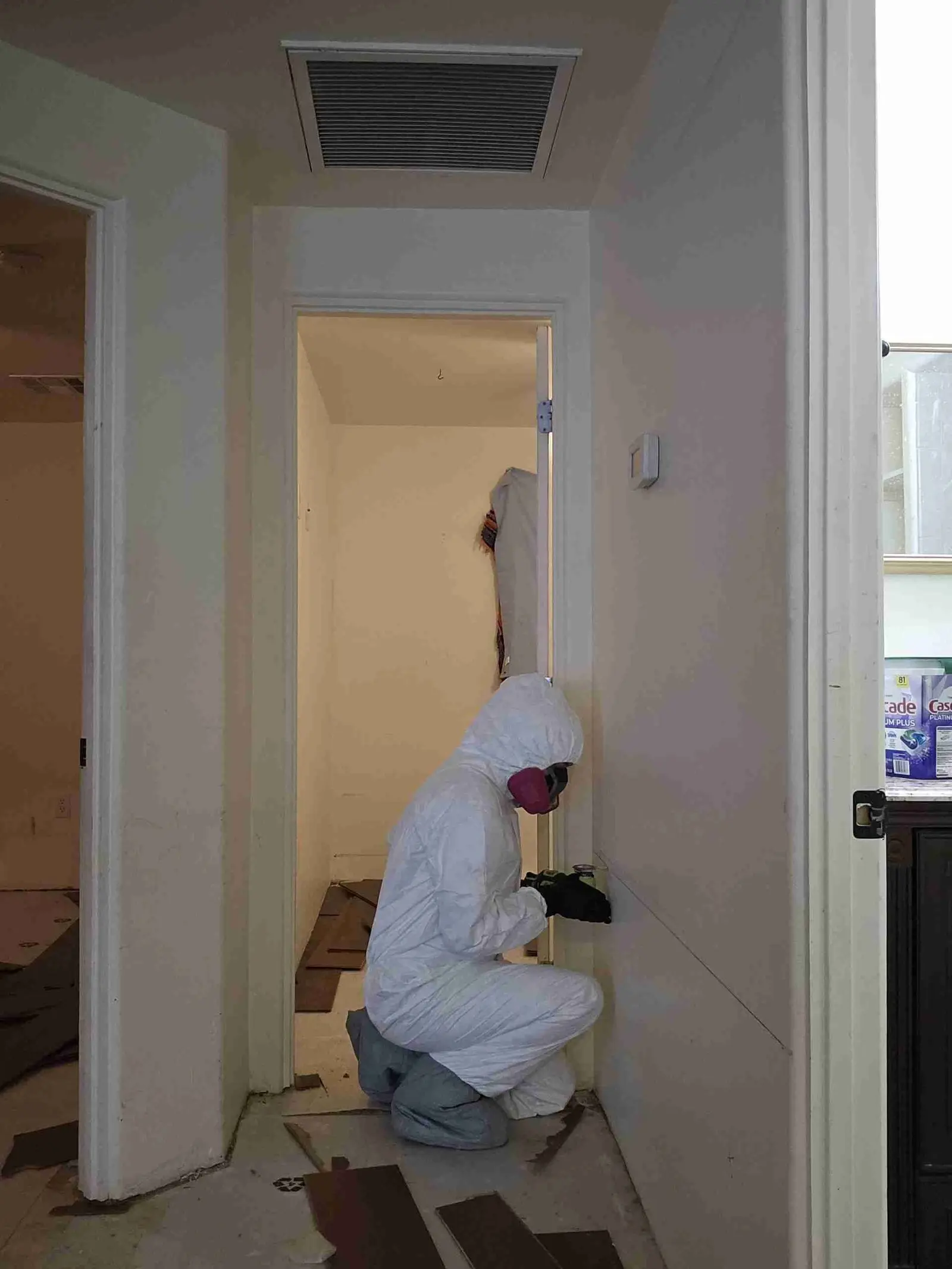 Rapid Response technician in a full protective suit working inside a containment area