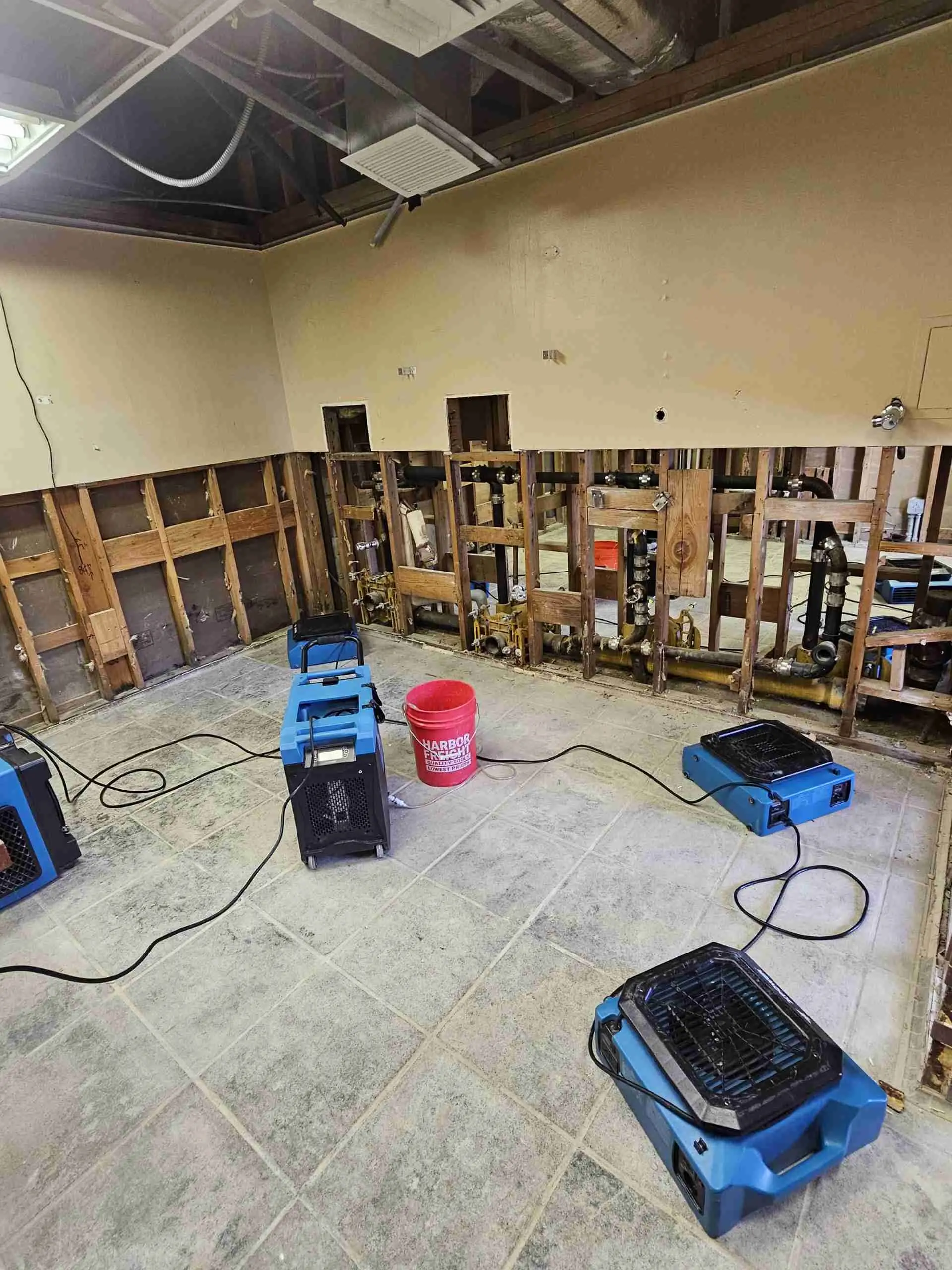 Room with walls opened to the studs and drying equipment running on a Rapid Response job